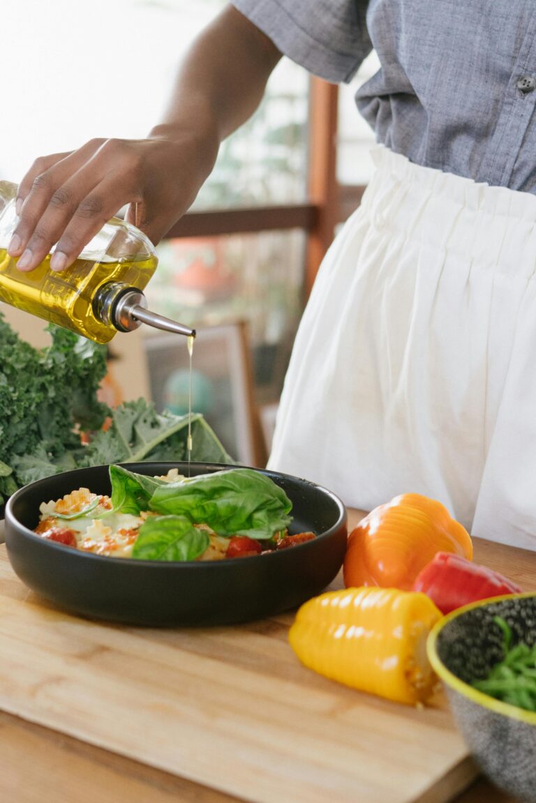 blanc hand olive oil cooking greens peppers cast iron apron kitchen meal prep